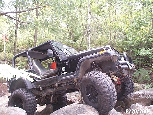 Black Jeep Wrangler on rocks, '04