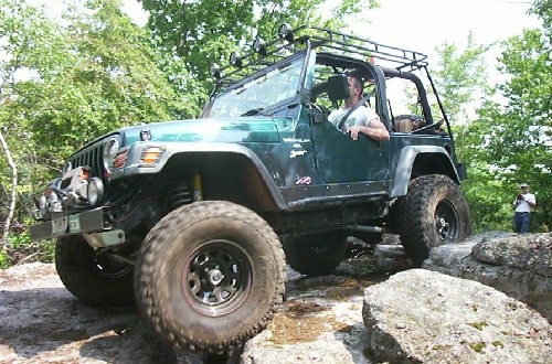 Man driving modified Jeep Wrangler off-road