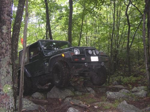 Black Jeep navigating rocky terrain on Long Island Off Road