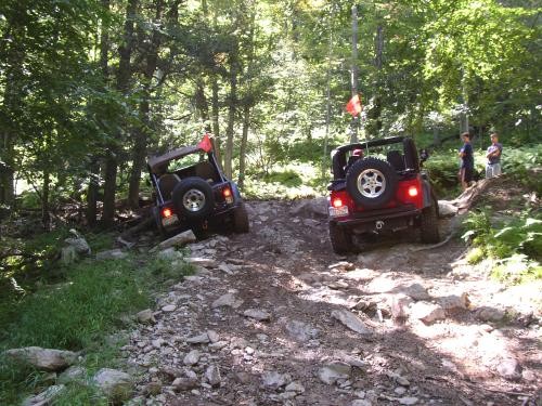Two Jeeps navigating rocky trail
