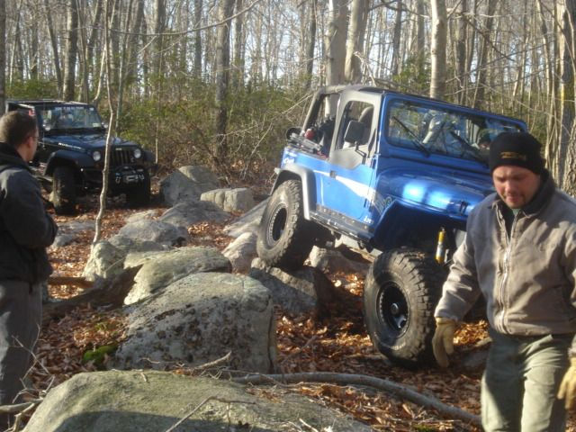Blue Jeep navigating rocks, off-roading
