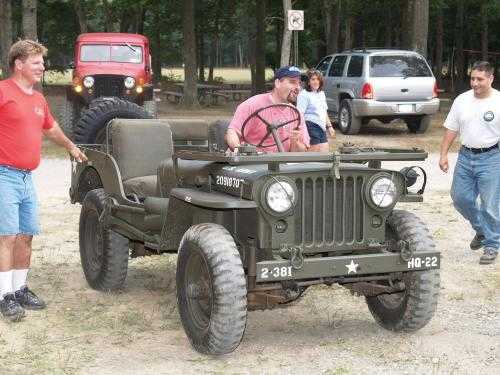 Man driving vintage military Jeep
