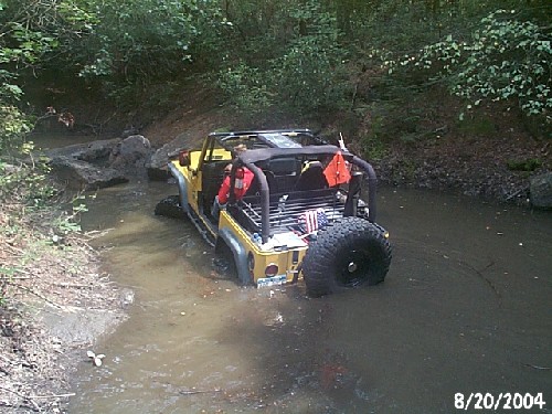 Yellow Jeep in creek bed