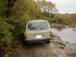 Tan Toyota Land Cruiser off-roading