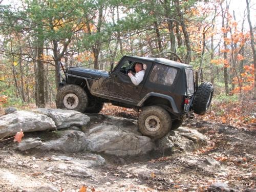 Man driving Jeep on rocks