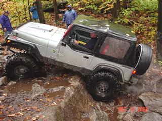 Silver Jeep navigating rocky terrain