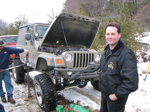 Man smiling near lifted Jeep