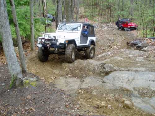 White Jeep navigating rocky trail