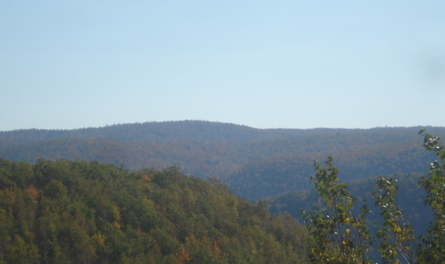 Panoramic view of tree-covered hills and distant mountains