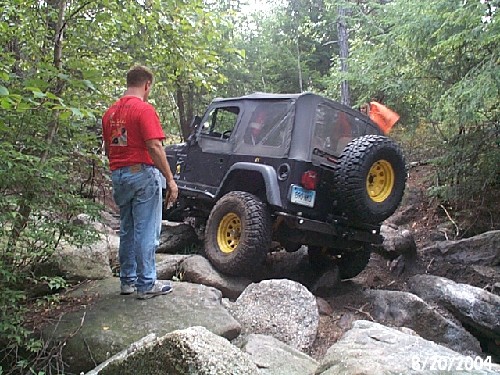 Man watching Jeep navigate rocks