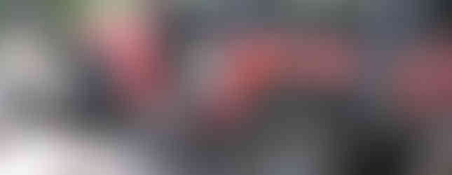 Red Jeep navigating rocky terrain