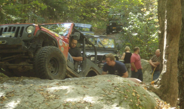 Off-roaders navigate rocky terrain in Jeeps