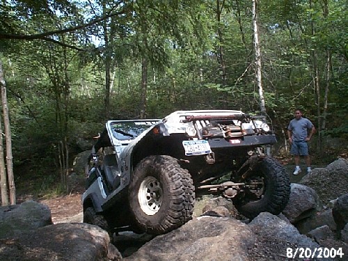 Silver Jeep navigating rocks, Long Island Off Road