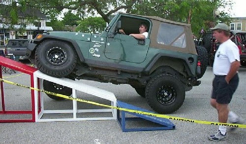 Teen driving Jeep up ramp; Long Island Off Road