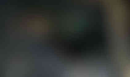 Green Jeep traversing rocky terrain