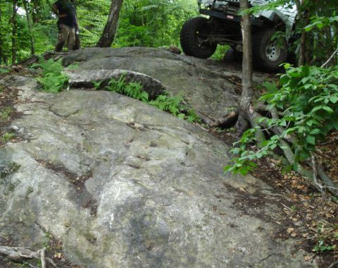 Off-road vehicle navigating rocky trail