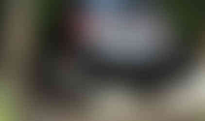 Red Jeep Wrangler off-roading over rocks