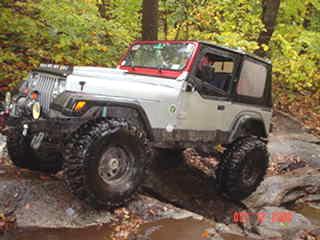 White Jeep Wrangler off-roading