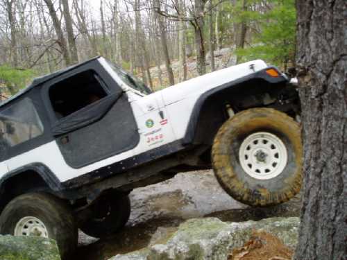 White Jeep navigating rocky terrain