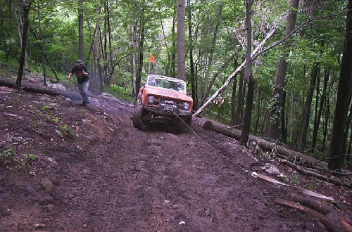 Man winching Bronco off-road