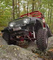 Jeep traversing rocks on trail