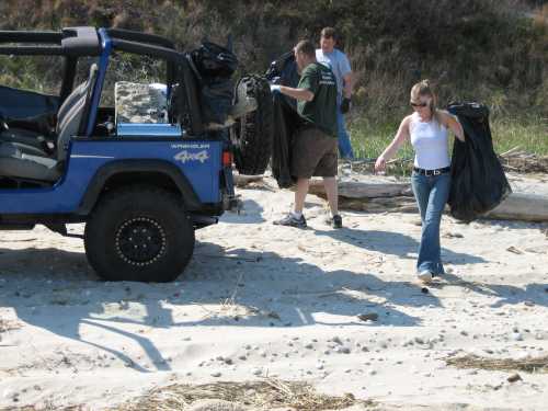 Volunteers cleaning beach; Jeep