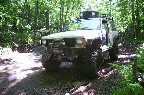 Off-road Jeep traversing muddy trail