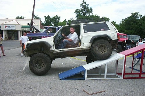 Man smiling in modified Jeep on ramp