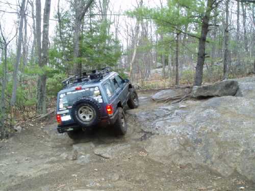 Jeep navigating rocky off-road trail