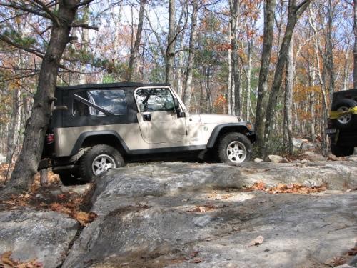 Tan Jeep on rocky trail
