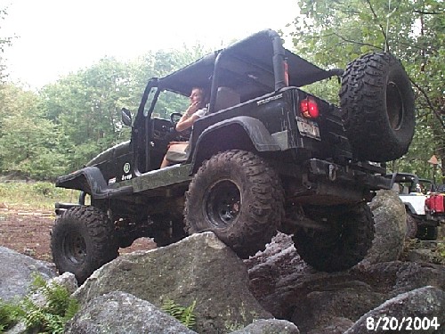 Man driving modified Jeep over rocks