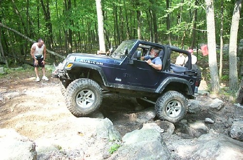 Man driving Jeep Wrangler on rocks