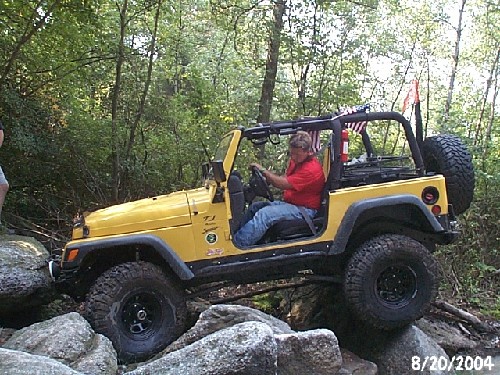 Yellow Jeep navigating rocks, Long Island Off Road