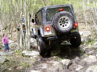 Jeep navigating rocky off-road trail