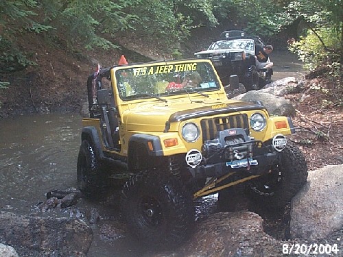 Yellow Jeep traversing rocky terrain, It's a Jeep Thing