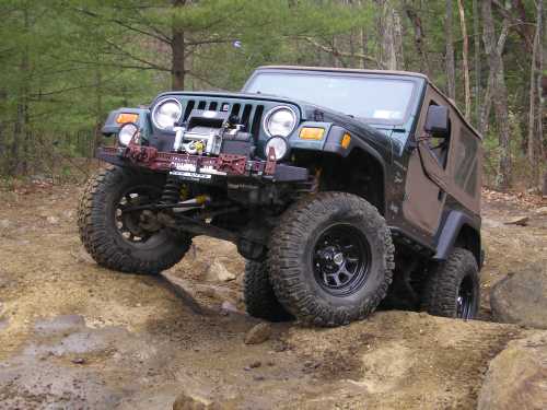 Green Jeep Wrangler off-roading