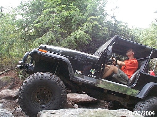 Man driving Jeep on rocks
