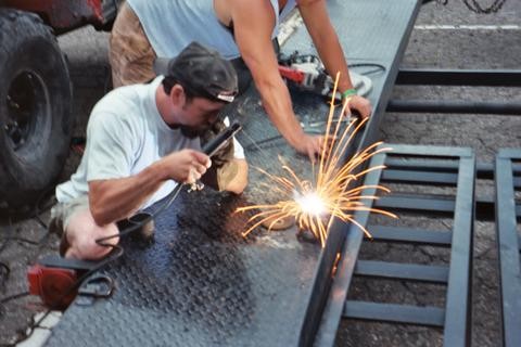 Two welders working on metal construction