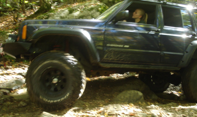 Person driving Jeep Wrangler off-road