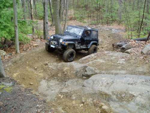 Black Jeep navigating rocky terrain