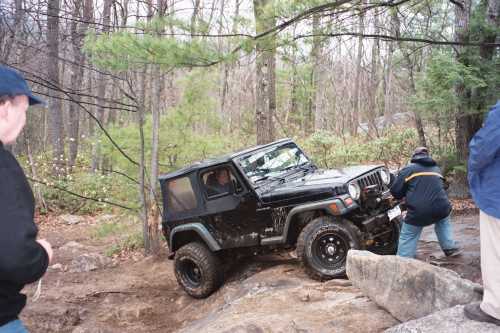 Black Jeep navigating rocky terrain