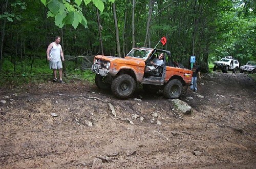 Orange Ford Bronco off-roading
