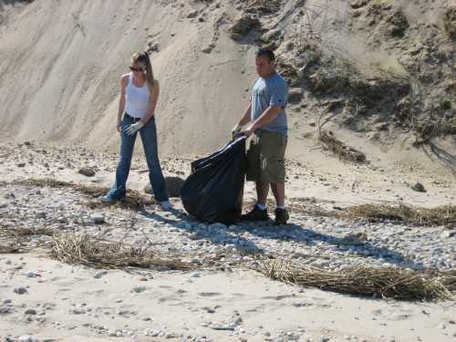 Two people cleaning beach, Long Island Off Road