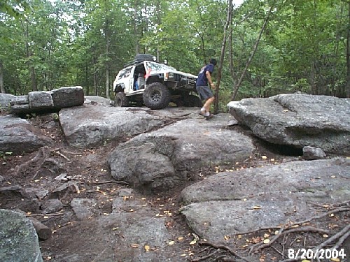 Man maneuvering 4x4 over rocks