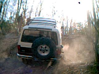 White Ford Bronco traversing a dirt trail