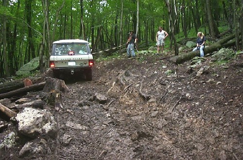 White Range Rover navigating rocky terrain
