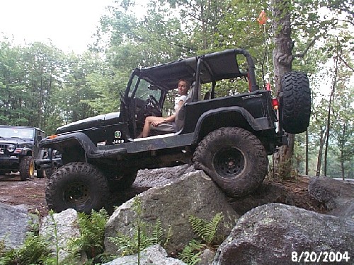 Woman in Jeep traversing rocks