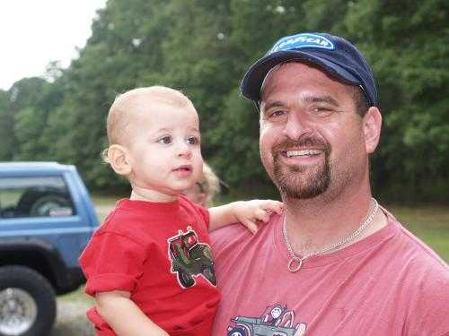Smiling man holding toddler