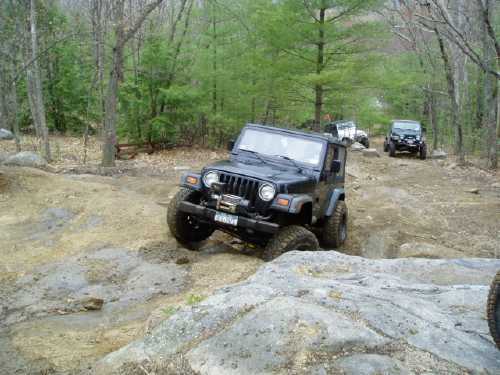 Jeep traversing rocky off-road trail