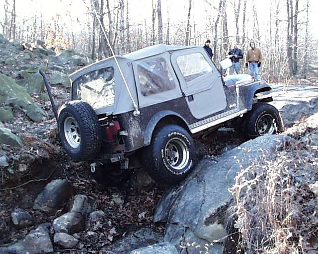 Gray Jeep navigating rocky terrain